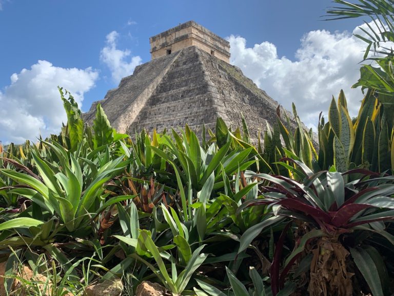 Photo of the El Castillo/Temple of Kukulkan at Chichen Itza, surrounded by flowers