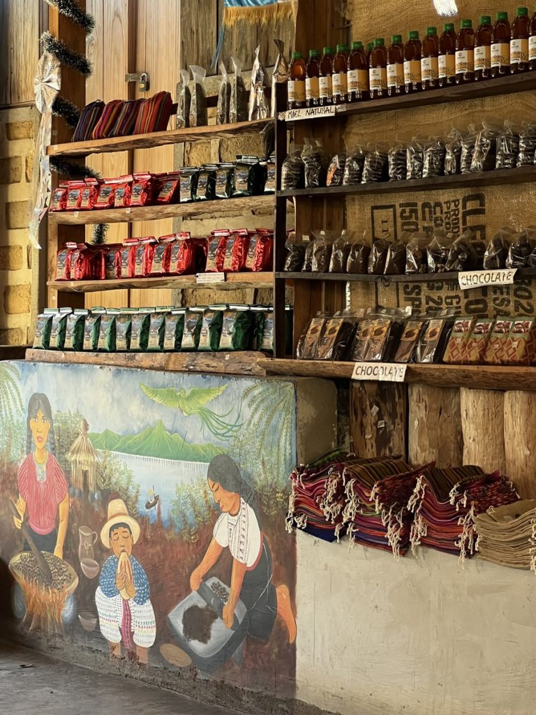 photo of a cafe in San Juan, Lake Atitlan showing a painting and coffee products