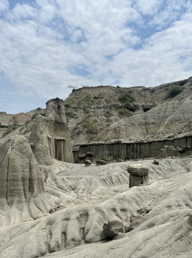 photo of rock formations in grey desert