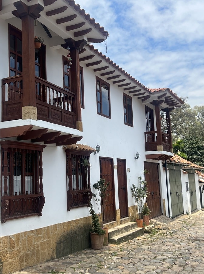 photo of a white building with wood windows and balconies in villa de leyva