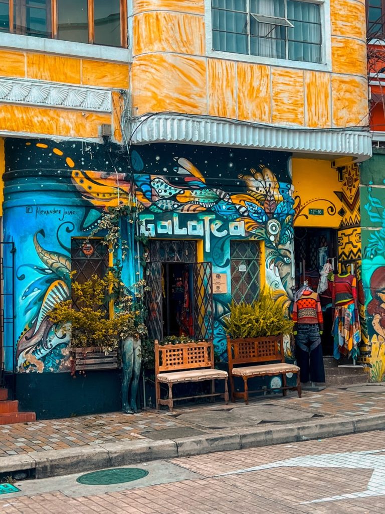 photo of a cafe in la candelaria with a street art mural