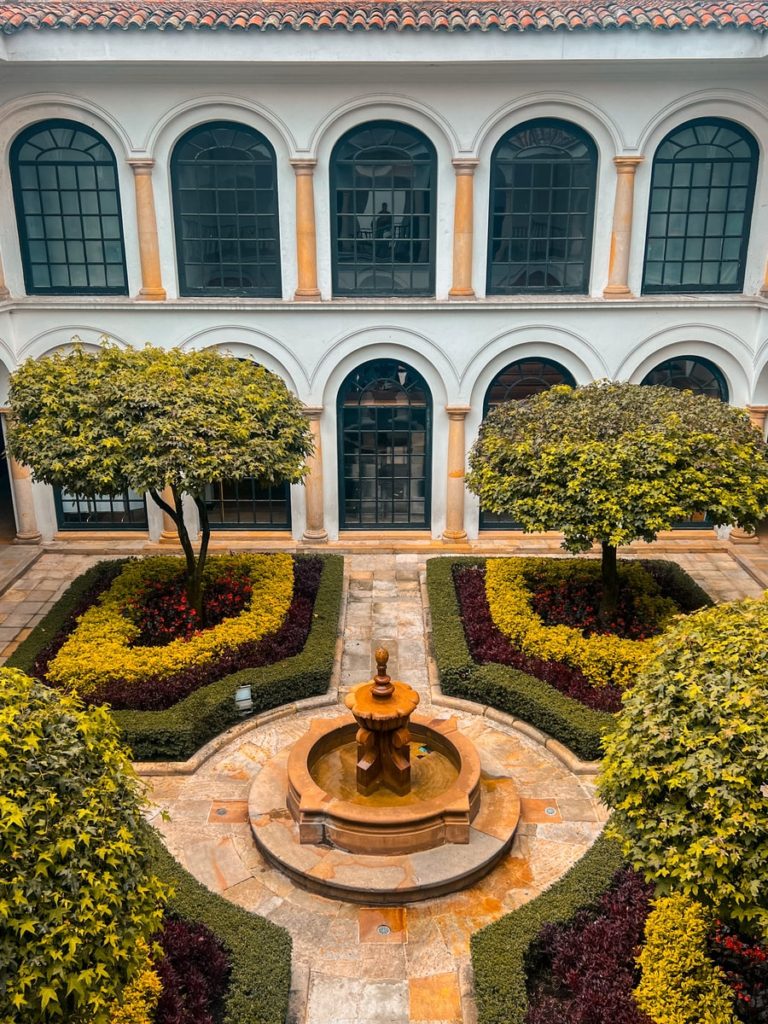 photo of a courtyard with a water fountain in the middle, botero museum bogota