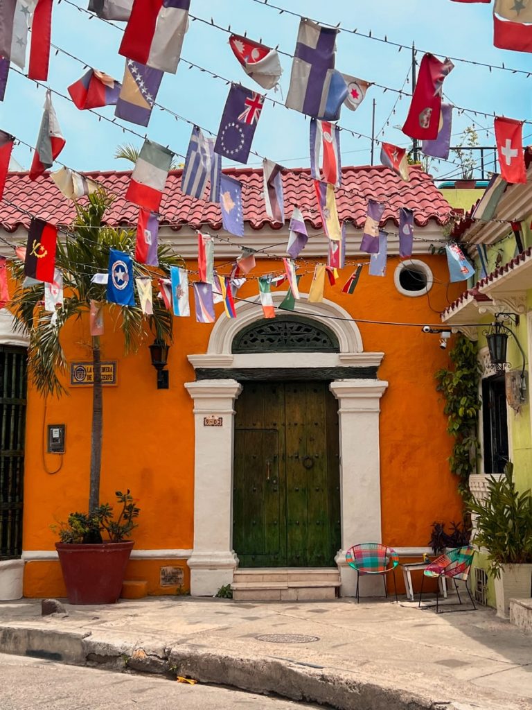 photo of flag street in cartagena with orange building
