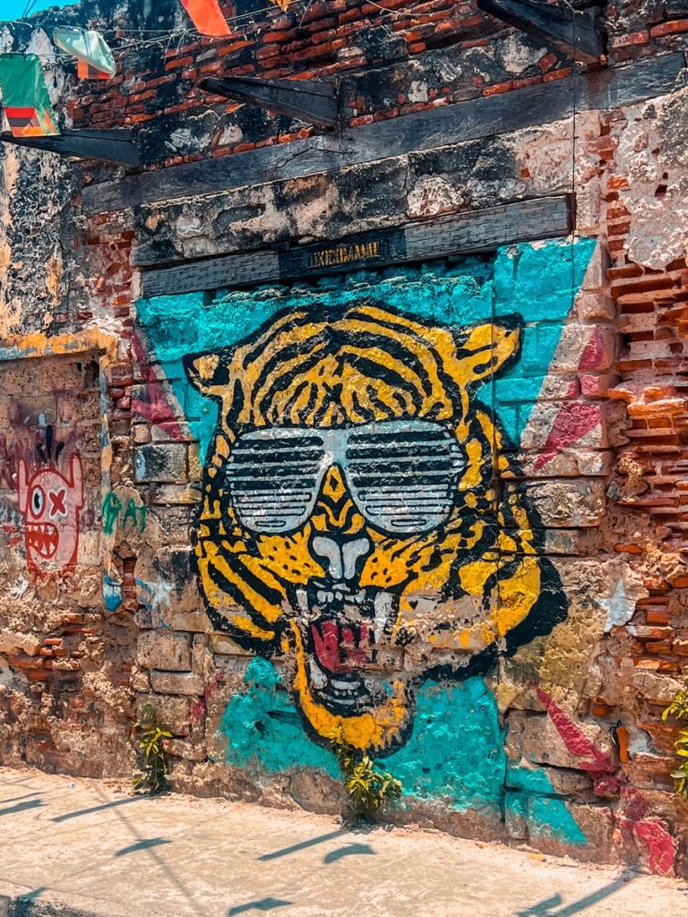 street art of a tiger on a brick wall