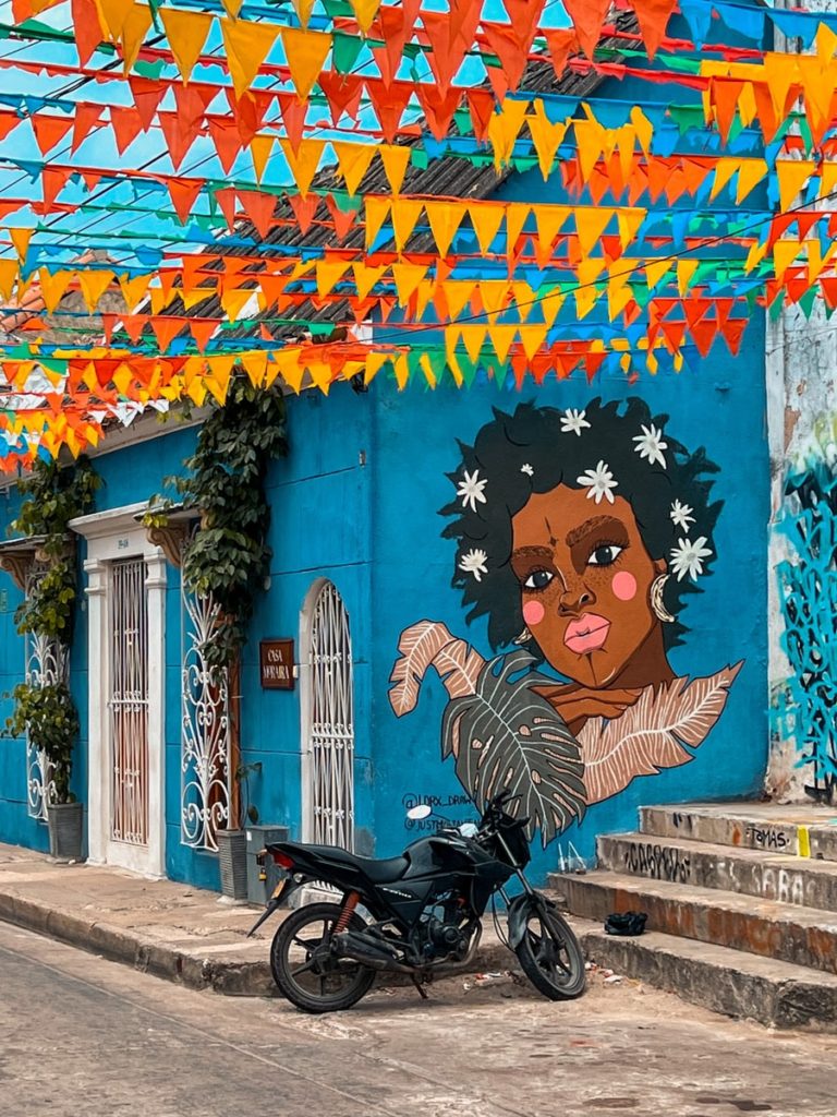 photo of street art in getsemani, with flags and a motorbike
