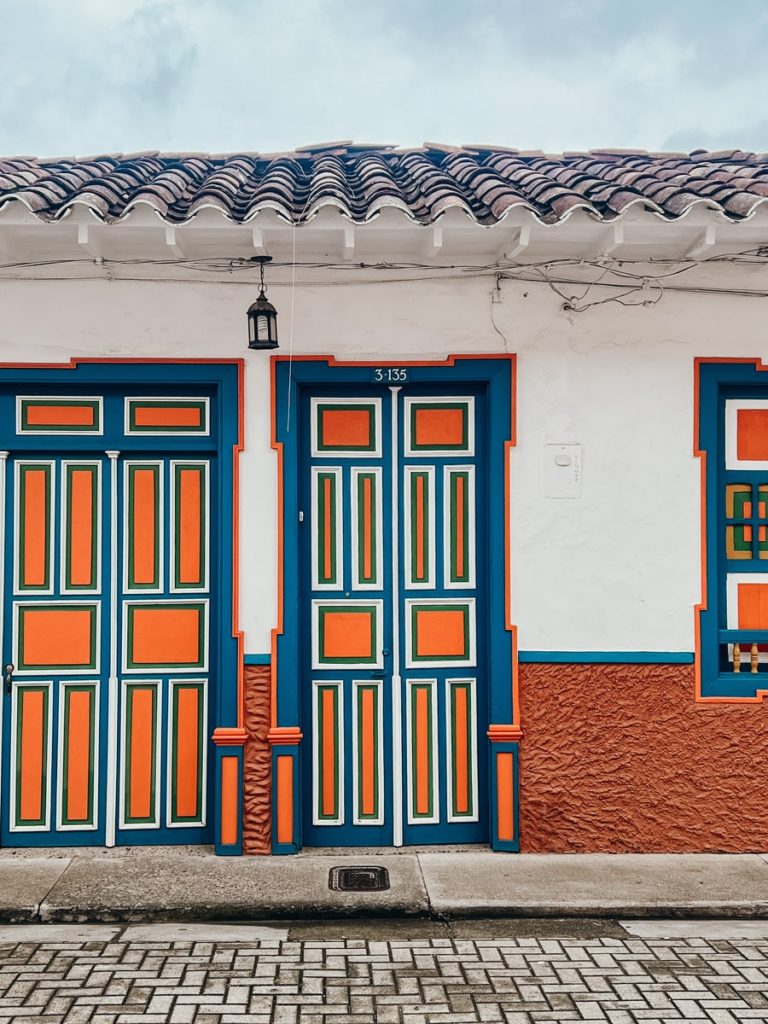 photo of orange and blue door in jerico, colombia