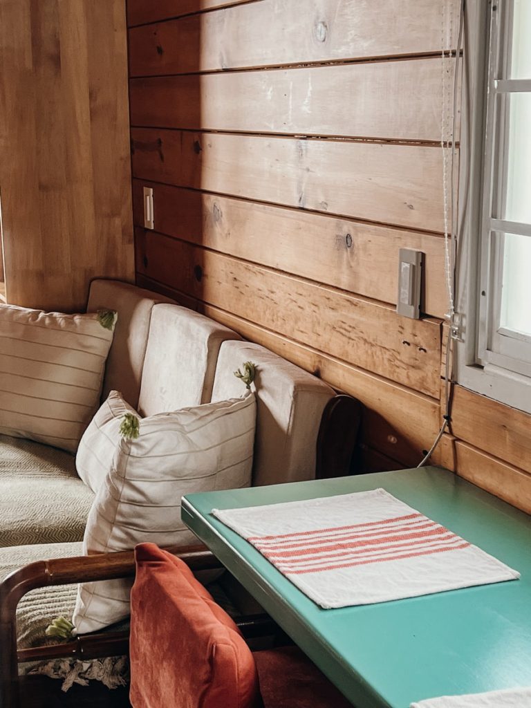 photo of corner of sofa and blue table in a cabin