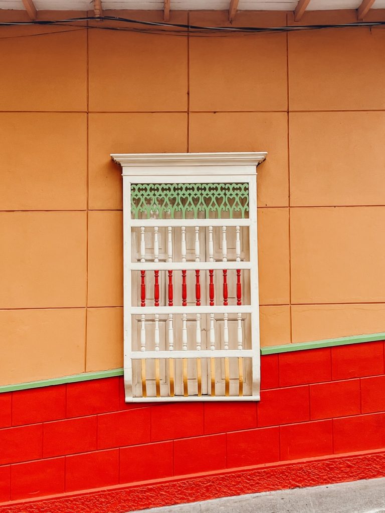 photo of window in jerico, orange+red wall with white detailed window