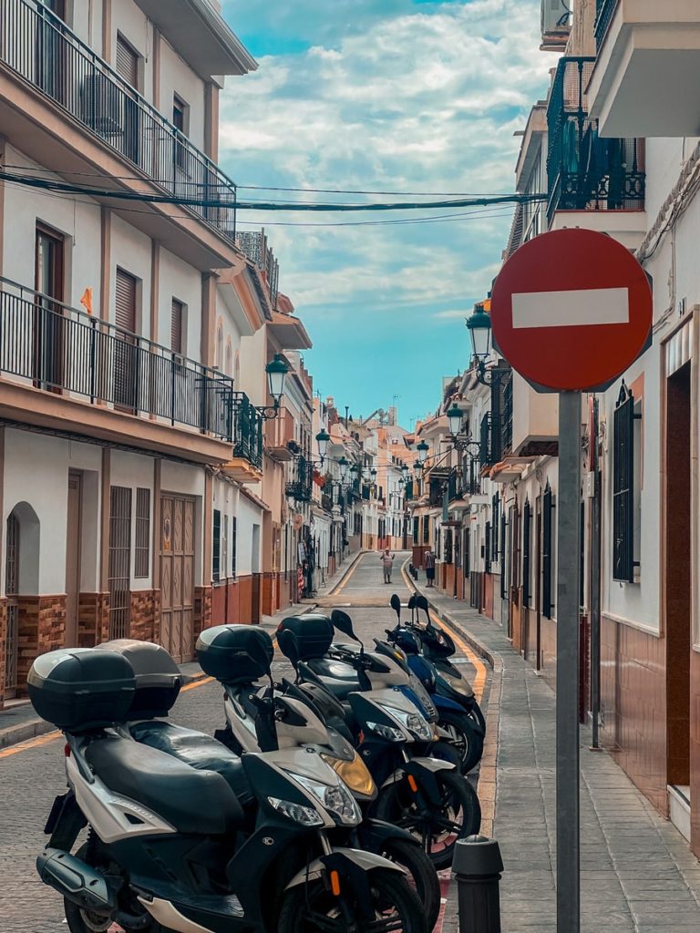 streets of Nerja with motorcycles in forefront of photo