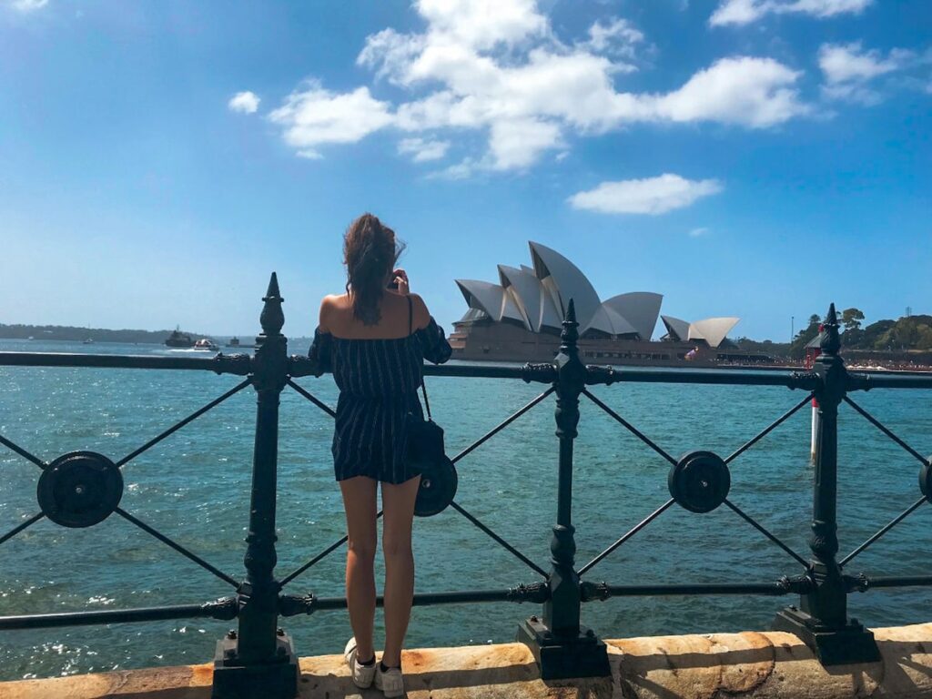 Girl taking photo of Sydney Opera House, Australia