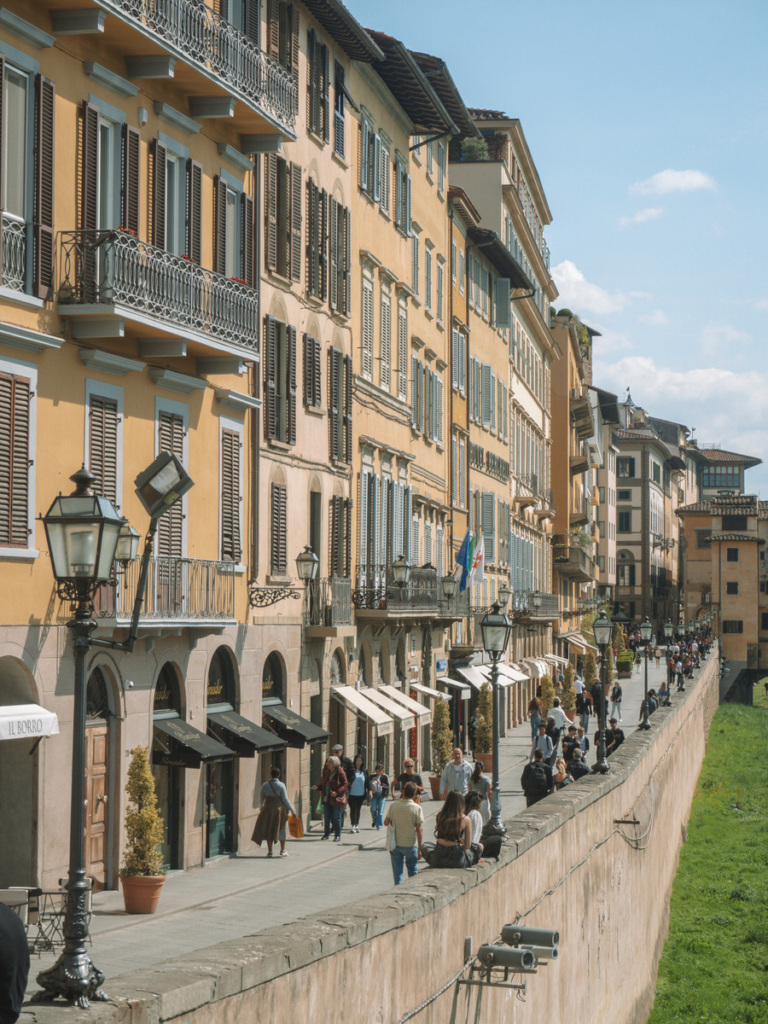 photo of riverside path in Florence, with many people