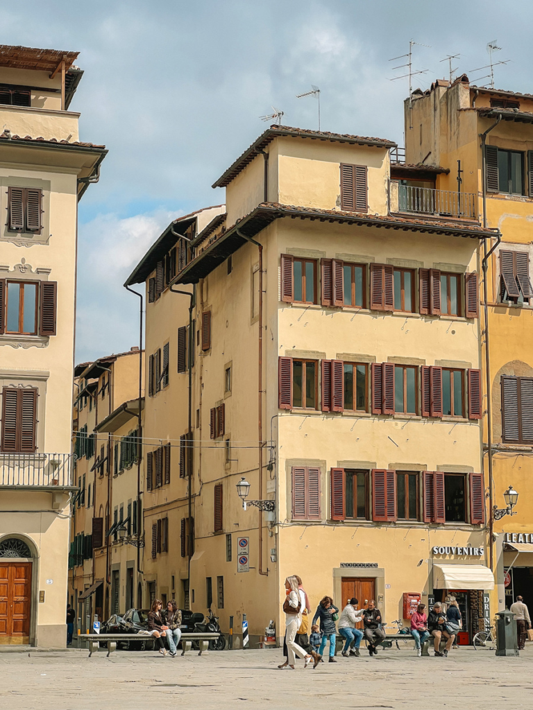 photo of people sitting in a square in florence